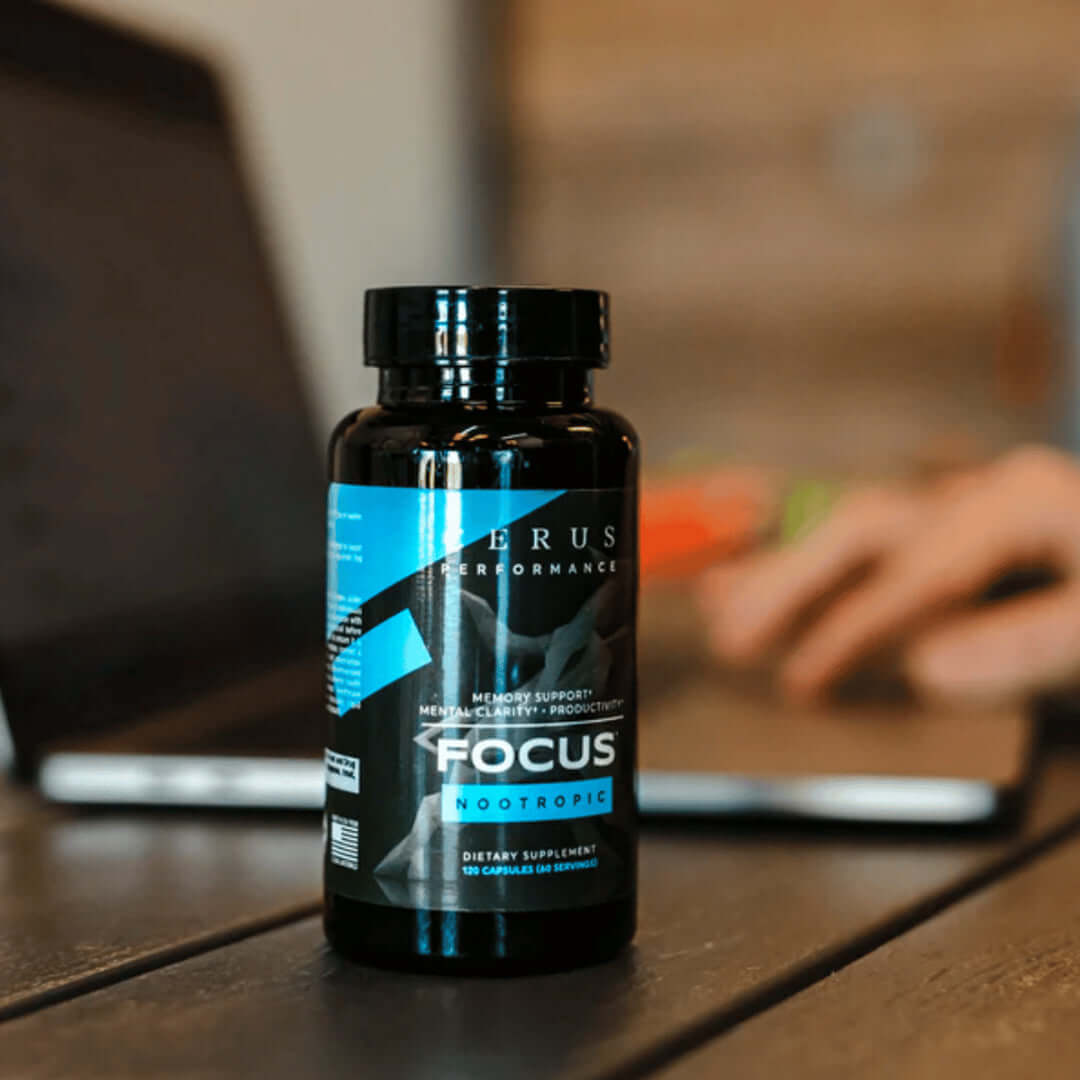 bottle of Focus next to a computer
