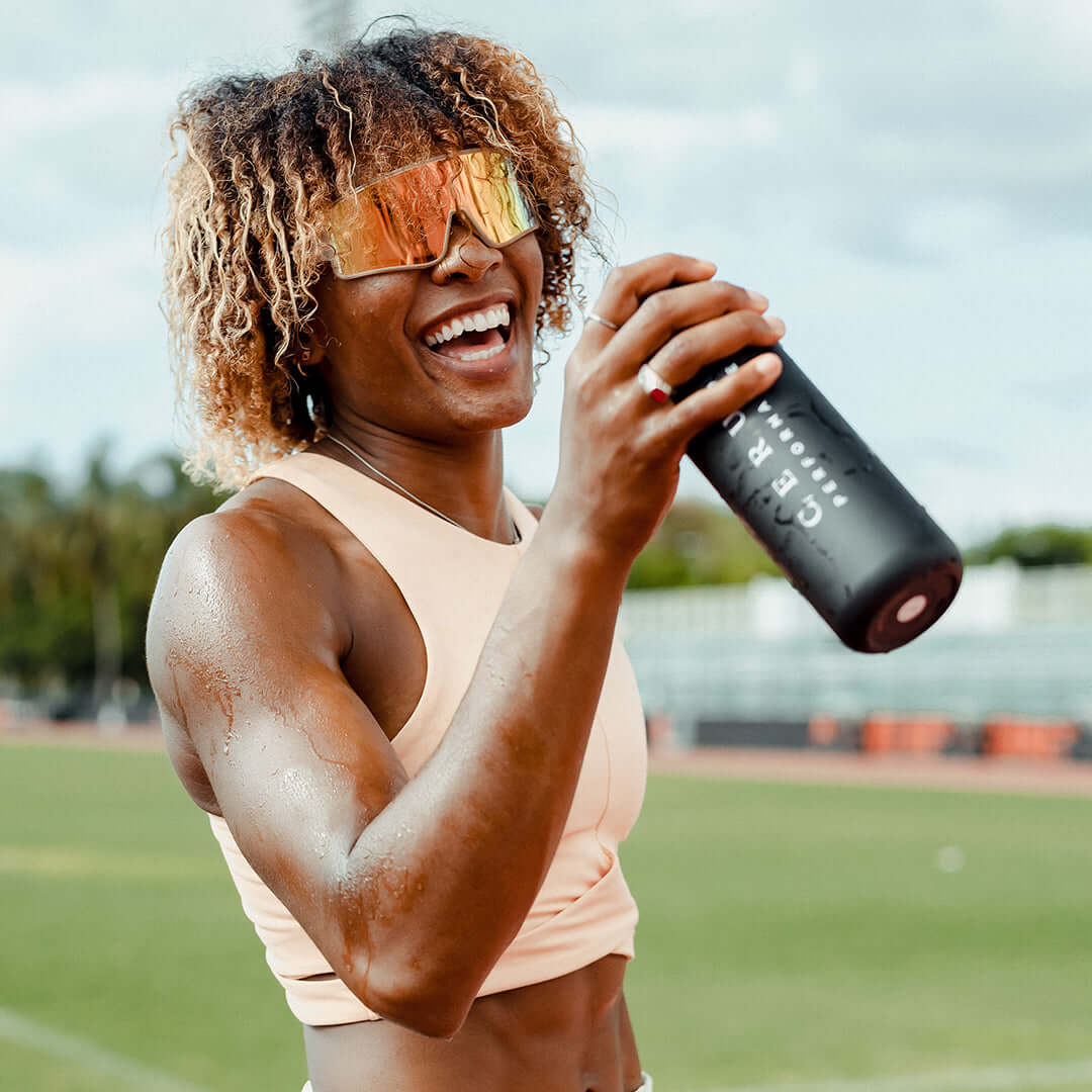 athlete drinking out of Cerus stainless steel water bottle